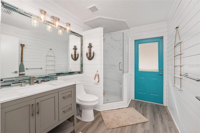 bathroom featuring hardwood / wood-style floors, toilet, an enclosed shower, and wooden walls