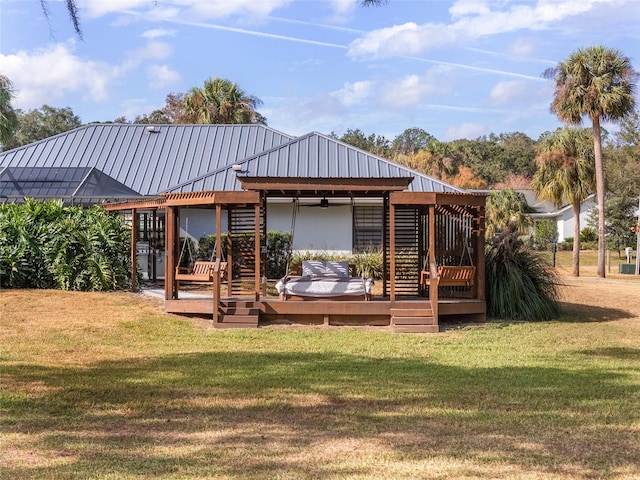 back of property with a lawn and a wooden deck