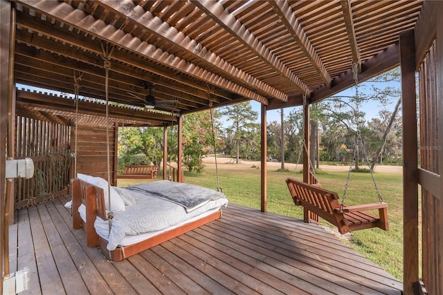 deck featuring ceiling fan, a yard, and a pergola