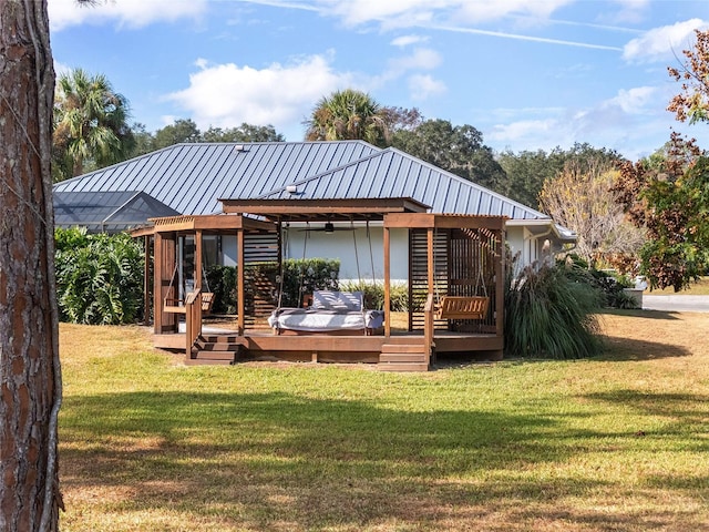 back of house featuring a wooden deck and a yard