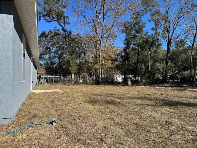 view of yard featuring central air condition unit