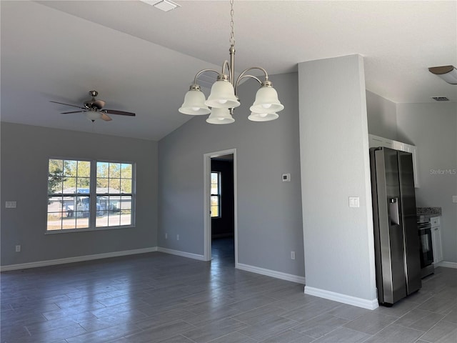 unfurnished room with ceiling fan with notable chandelier and lofted ceiling