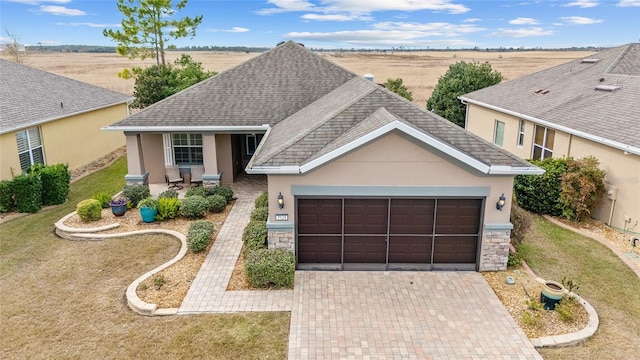 view of front of house featuring a front lawn and a garage