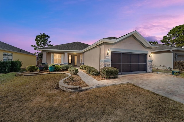 view of front of house featuring a garage and a yard