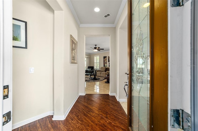 corridor with hardwood / wood-style floors and crown molding