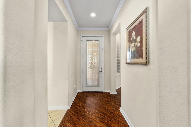 doorway to outside with hardwood / wood-style floors and ornamental molding