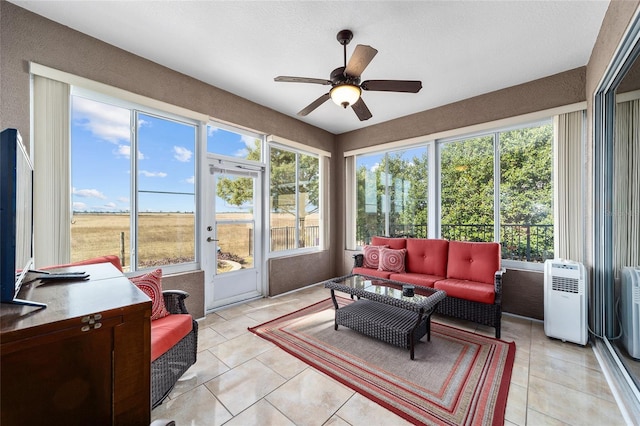 sunroom featuring ceiling fan