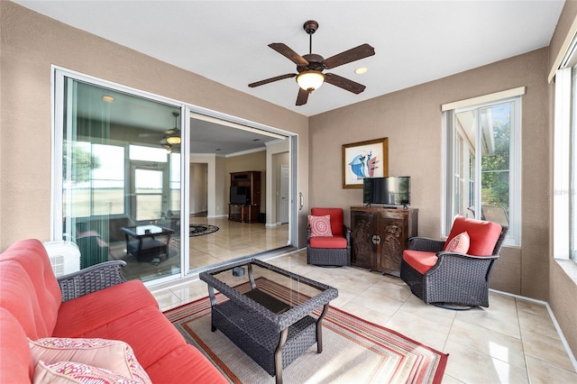 tiled living room featuring ceiling fan and ornamental molding