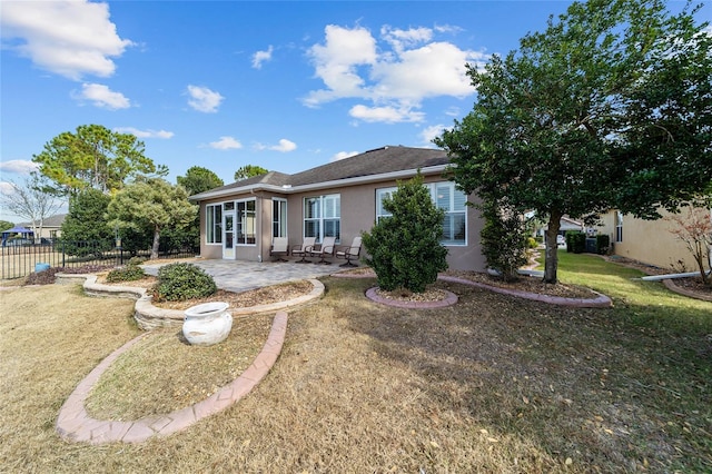 back of property featuring a patio area and a yard