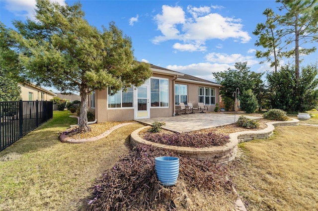 back of property featuring a yard and a patio area