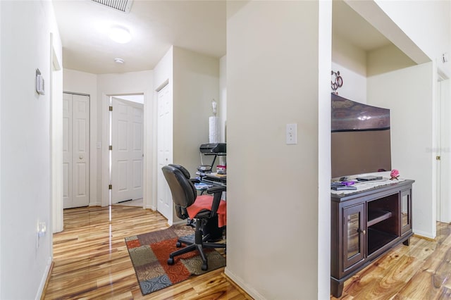 home office with hardwood / wood-style floors