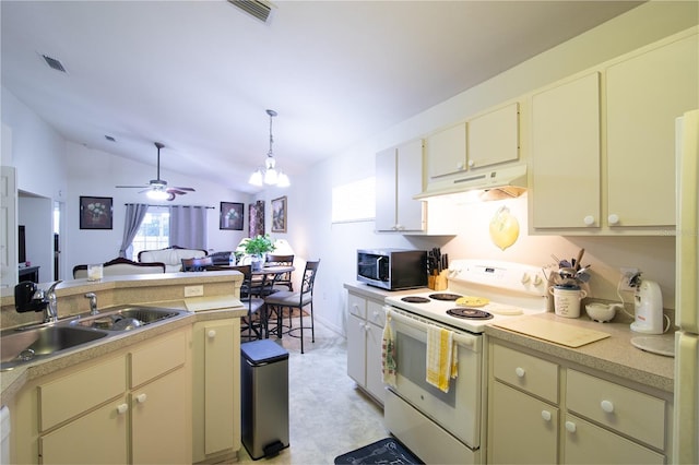 kitchen with white electric range oven, lofted ceiling, sink, and cream cabinets