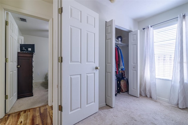 bedroom featuring light wood-type flooring and a closet