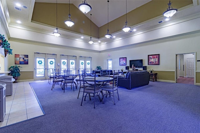 carpeted dining room featuring high vaulted ceiling and french doors