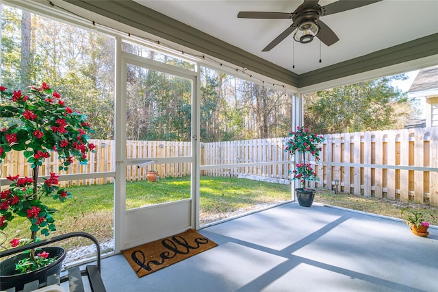 unfurnished sunroom featuring ceiling fan