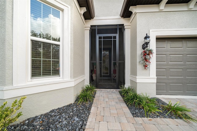 view of exterior entry featuring a garage