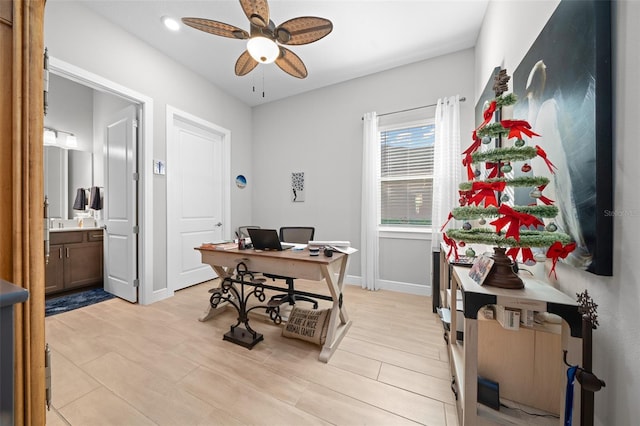 home office with ceiling fan and light hardwood / wood-style floors