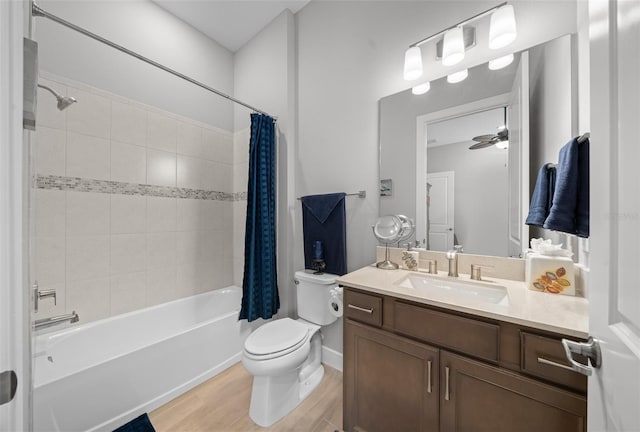 full bathroom featuring ceiling fan, shower / bath combo, hardwood / wood-style floors, toilet, and vanity