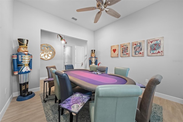 dining area with wood-type flooring and ceiling fan