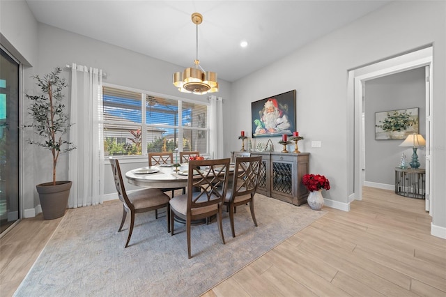 dining room with a notable chandelier and light hardwood / wood-style flooring