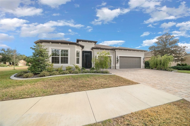 view of front facade featuring a garage and a front lawn