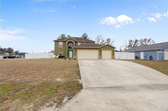 view of front property featuring a garage and a front lawn