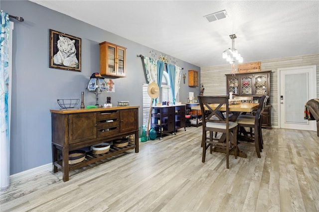 dining area with a notable chandelier and light wood-type flooring