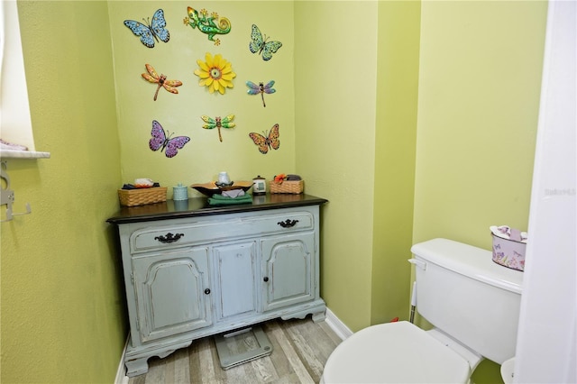 bathroom with wood-type flooring and toilet