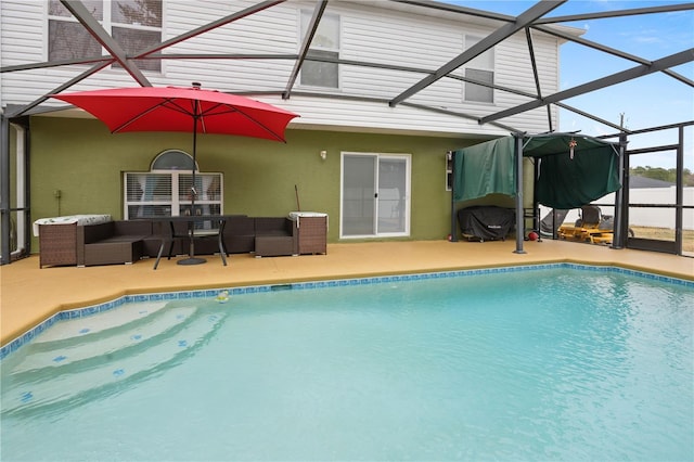 view of swimming pool with outdoor lounge area, a patio area, and glass enclosure