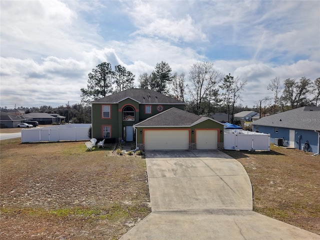 view of front of home featuring a garage and central air condition unit