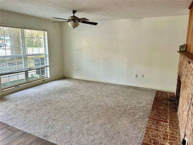 unfurnished living room with a fireplace, hardwood / wood-style floors, a textured ceiling, and ceiling fan