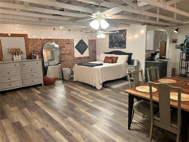 bedroom featuring beamed ceiling, ceiling fan, brick wall, and light hardwood / wood-style flooring