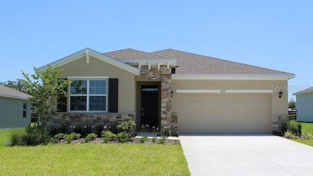 view of front of property featuring a garage and a front lawn