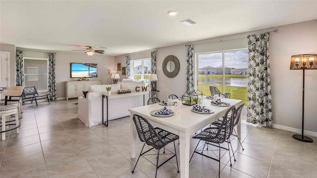 dining space with ceiling fan and light tile patterned floors