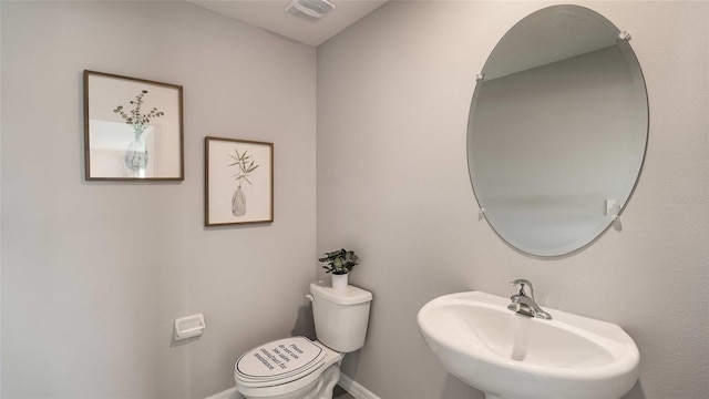 bathroom featuring toilet and sink