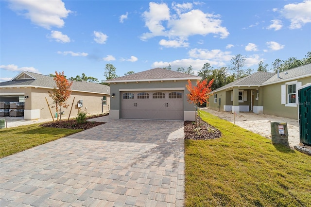 ranch-style house featuring a garage and a front yard