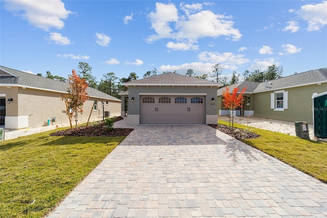 ranch-style home featuring a front lawn and a garage