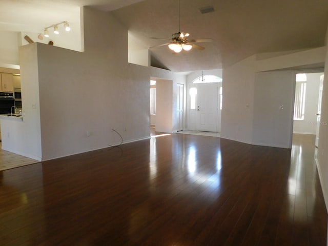 unfurnished living room with high vaulted ceiling, dark hardwood / wood-style floors, and ceiling fan