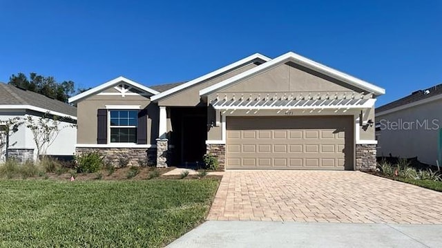 craftsman house featuring a front yard and a garage