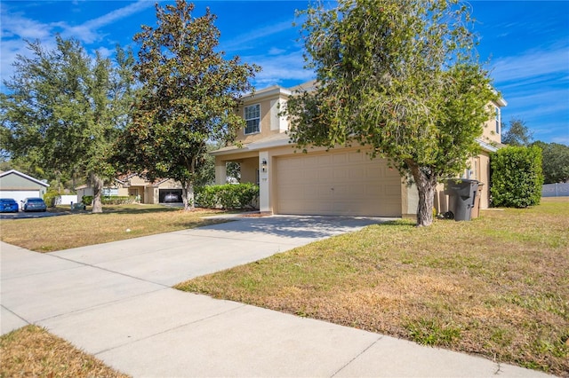 view of property hidden behind natural elements featuring a garage and a front lawn