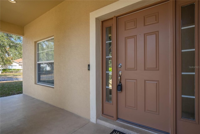 doorway to property featuring a porch