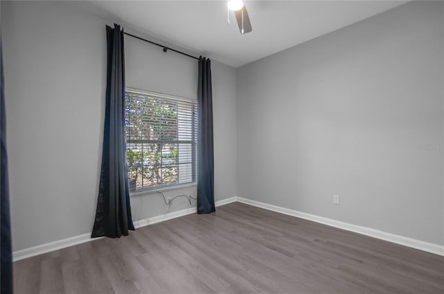 empty room with hardwood / wood-style flooring and ceiling fan