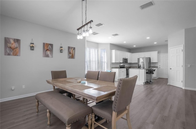 dining room with hardwood / wood-style flooring