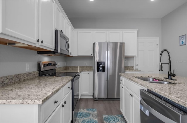 kitchen featuring appliances with stainless steel finishes, dark hardwood / wood-style flooring, white cabinetry, and sink