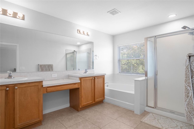 bathroom with tile patterned flooring, vanity, and independent shower and bath