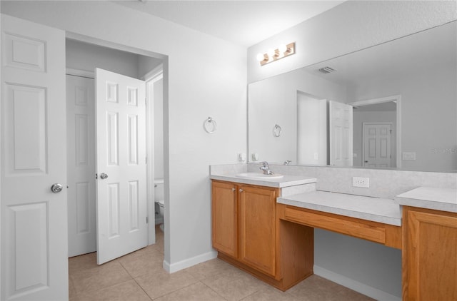 bathroom featuring tile patterned flooring, vanity, and toilet