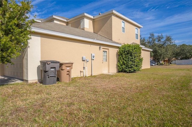 back of property with a lawn