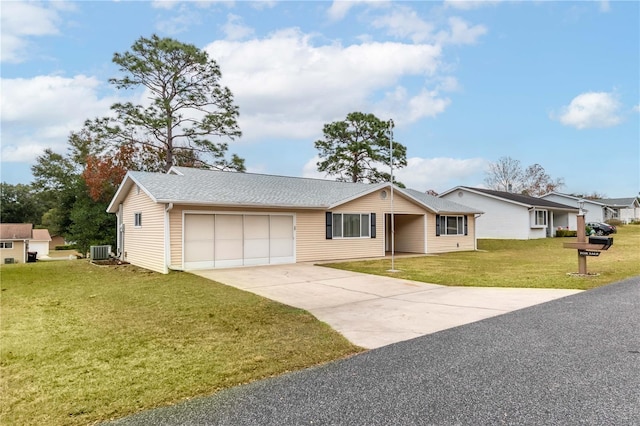 ranch-style home with a garage, cooling unit, and a front lawn