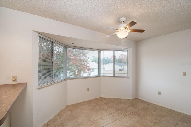 spare room with ceiling fan and a textured ceiling