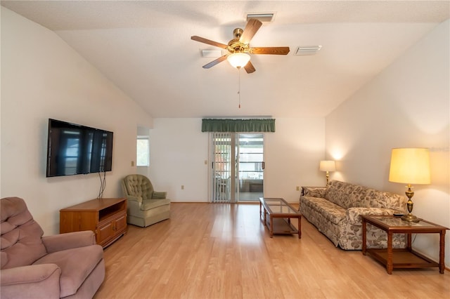 living room with vaulted ceiling, ceiling fan, and light wood-type flooring